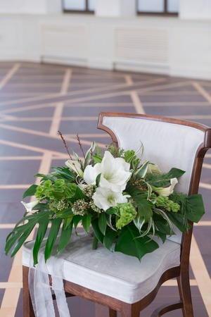 Wedding bouquet of tropical flowers. Blossom tropical flowers and palm leaves, monstera leafs, callas of white and green colors.の写真素材