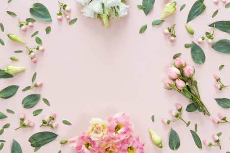 Top view of flower pattern of pink and beige buds, green leaves, branches and berries on pink background with copy space. Flat lay, top view. Flowers textureの写真素材