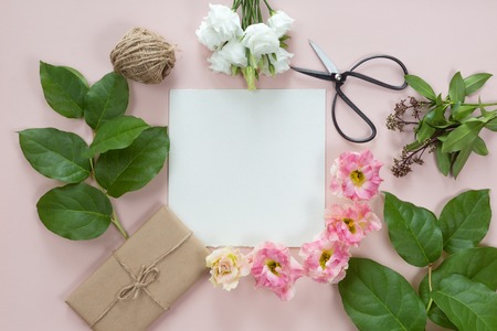 Flowers composition with gift on white pink background. Flat lay, top view.の写真素材