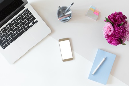 Top view of office table desk or fashion woman workspace with computer keyboard, blue diary, green potted cactus flower background. Flat layの写真素材