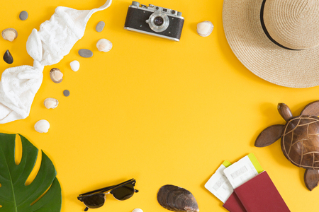 Flat lay and top view of traveler accessories on yellow background with copy space. Travel, tropical trip and vacation concept. Summer background.の写真素材