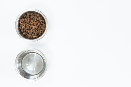 Dry dog food in metal bowl, top view and flat layの写真素材