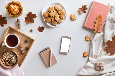 Flat lay, top view of vintage autumn woman office table desk. Workspace with laptop, maple leaves and flowers, diary on white background. Online shopping conceptの写真素材