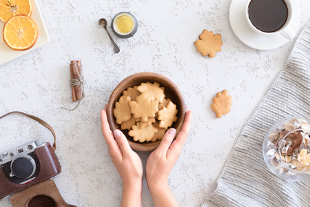 Flat lay of cozy autumn breakfast with homemade honey cookies and cup of tea, top viewの写真素材