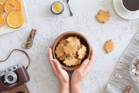 Top view of honey cookies in the shape of maple leaf on vintage autumn background, flat lay.の写真素材
