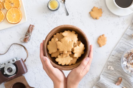 Top view of honey cookies in the shape of maple leaf on vintage autumn background, flat lay.の写真素材