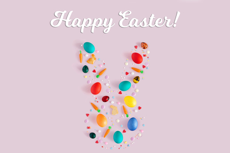 Top view and flat lay of arrangement decoration Happy Easter, holiday background concept. Colorful bunny cookies, eggs and topping ornament design as big rabbit on pink pastel deskの写真素材