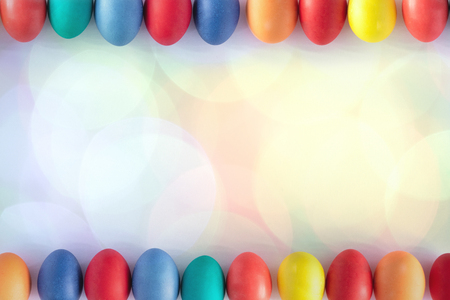 Top view and flat lay of pastel Colorful Easter egg frame on white background with bokeh lights, Happy Easter concept with copy spaceの写真素材