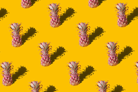 Summer colorful fruit pattern of fresh pineapples on yellow background with shadow