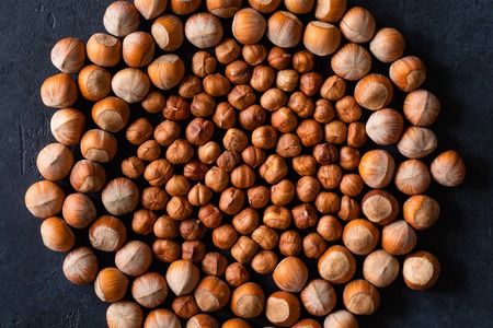 Top view of background texture of fresh natural unshelled raw Hazelnut, full frame and flat lay. Fresh organic filbert. macro Food background.の写真素材