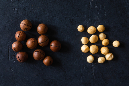 Top view of background texture of fresh natural unshelled raw macadamia nuts, full frame and flat layの写真素材