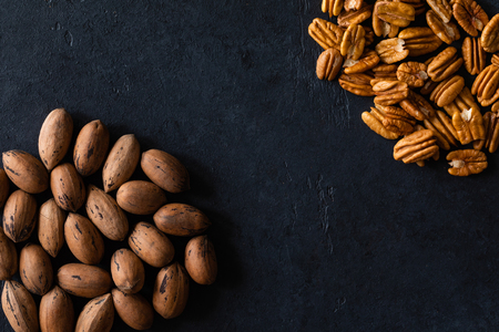 Natural pecan background pattern texture in-shell nuts, backdrop Pecans in shell top viewの写真素材