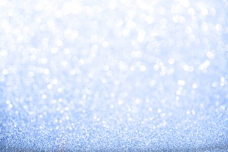 Blue blurred glitter background. Sparkling and shiny texture for Christmas and New Year holiday or seasonal wallpaper decorationの写真素材