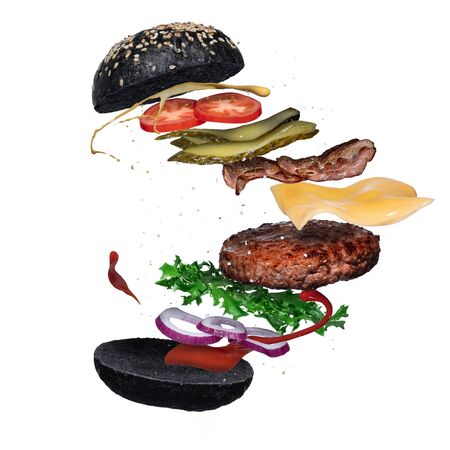 Floating black burger layer isolated on white background. Ingredients of a delicious hamburger with ground beef patty, lettuce, bacon, onions, tomatoes, cucumbers, splash of sauce and mustardの写真素材