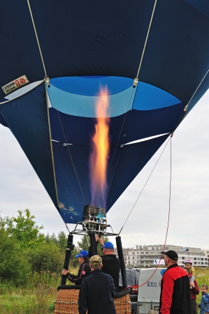 Warsaw, Poland - September 24, 2011 - Balloonists releases flame into the balloon during the First Balloon Fiesta on Mayor Cup Wilanow.のeditorial素材