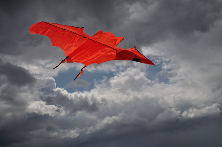Kite flying in a cloudy skyの写真素材