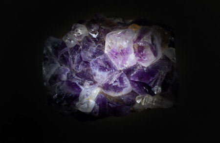 Ultra macro close up of a natural purple Amethyst quartz cluster isolated on black backgroundの写真素材