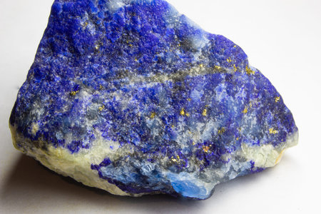 Raw Lapis lazuli rock on white background. Unpolished chunk of lapis lazuli sitting on white...