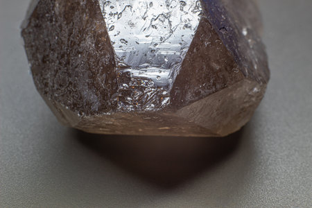 Macro gray brown smoky quartz natural point isolated on black surfaceの写真素材