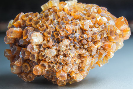 Aragonite cluster, orange crystal on top of the silver surface. Macro orange crystal photo. Crystal cluster chunkの写真素材