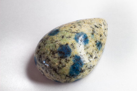K2 Jasper, K2 granite, raindrop azurite macro photography on a white surface. Macro photo of stone on a white background.の写真素材