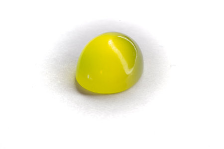 Two Peridots on top of each other on a white background. Olivine oval cut peridot cabochon.の写真素材