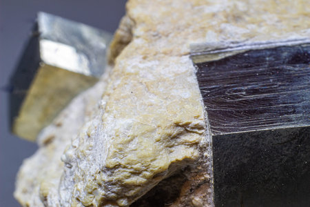 Macro cubical pyrite on white matrix isolated on gray background