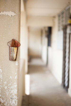 Weathered incense holder along a empty corridor.の写真素材