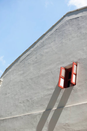Long shadow cast on a white wall.