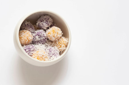 Cropped shot of rice cake stuffed with brown sugar and coated with grated coconut.