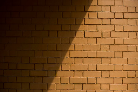 Shot of a background wall with a partial shadow cast over it at noonの写真素材