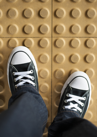 A pair of black sneaker on non slip flooringの写真素材