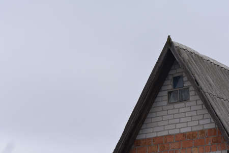 Cottage house roof with small windows to the atticの写真素材