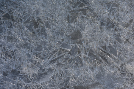 Ice texture frozen river in sunny winter day