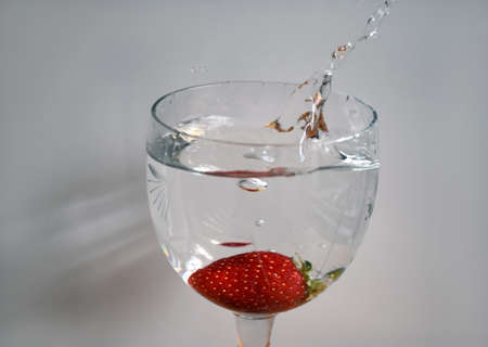 strawberry falling into the waterの写真素材
