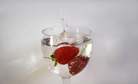 strawberry falling into the waterの写真素材