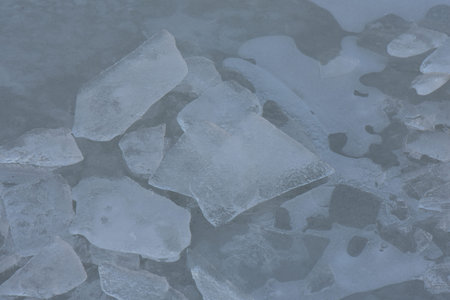 Ice on the frozen lake in the winter, close-up.
