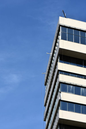 Detail of a modern office building with blue sky in the background