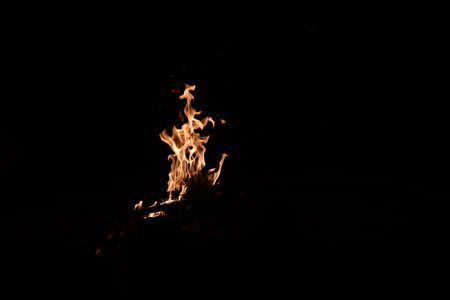 Fire flames isolated on black background. Burning bonfire at night.の写真素材