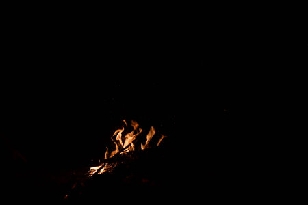 Fire flames on black background with copy space. Bonfire at night.