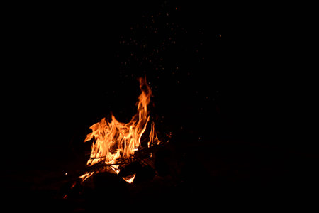 Flames of a campfire on a black background with copy spaceの写真素材