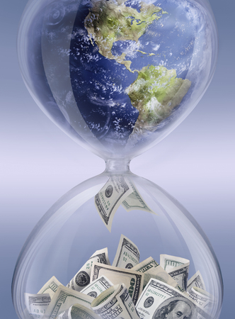 make money. Sand-glass with globe inside symbolizing business processの写真素材