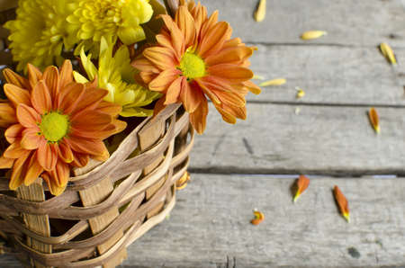 Basket full of flowers on retro desk.の写真素材