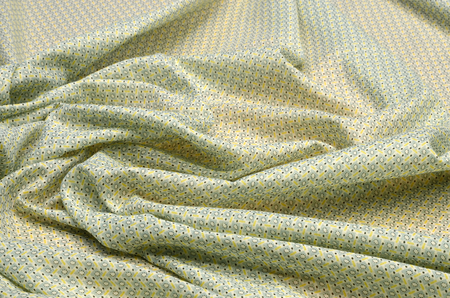 Cotton fabric, cambric with light yellow - green geometric ornamentの写真素材