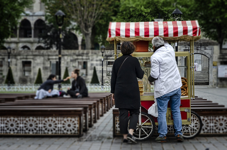 Street seller of fast food with bagle and simit on traditional turkish cart at Sultanahmet squareの写真素材