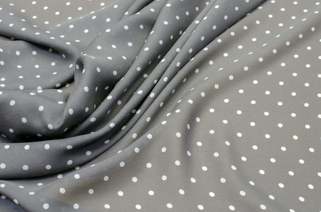 Silk fabric crepe de chine white peas on grayの写真素材