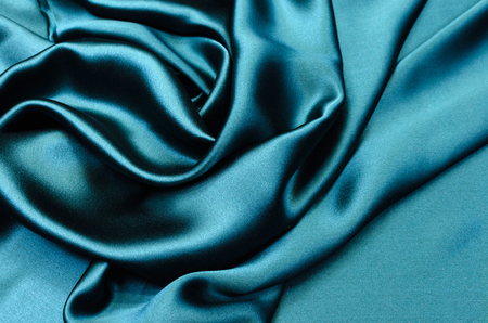 Silk, satin fabric in blue-green colorの写真素材