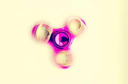 Spinning violet spinner on a yellow backgroundの写真素材