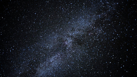 Milky Way Galaxy at night sky. Image contains grain, noise, blur and soft focus due to high ISO,...