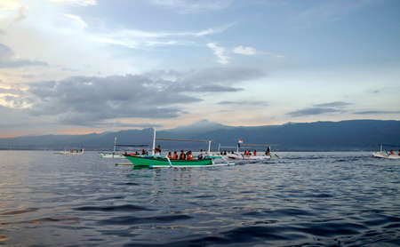 BALI, INDONESIA - MAY 20: Many tourists looking for dolphins at Lovina beach on May 20, 2012 in Bali, Indonesia. Popular activities for visitors include early-morning boat trips to see dolphins.のeditorial素材
